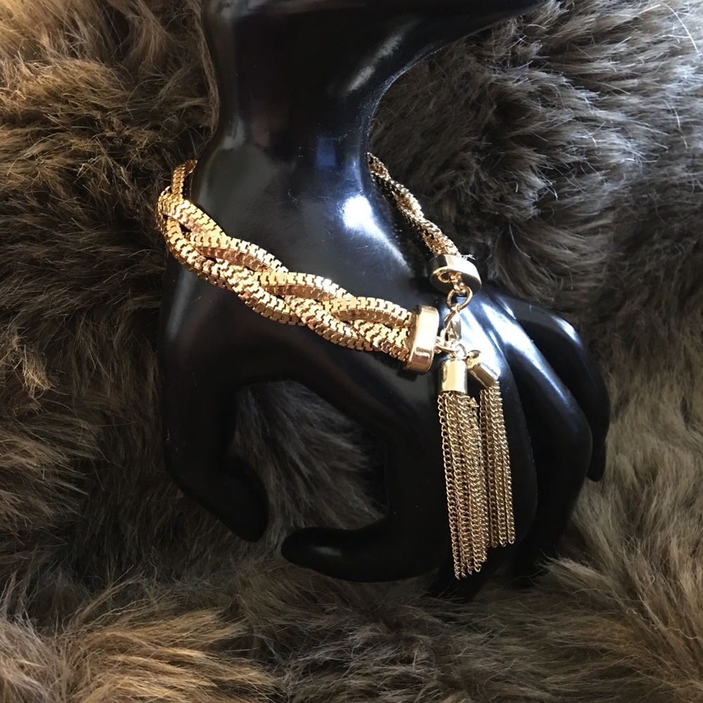 Gold tone braided chain bracelet with tassel